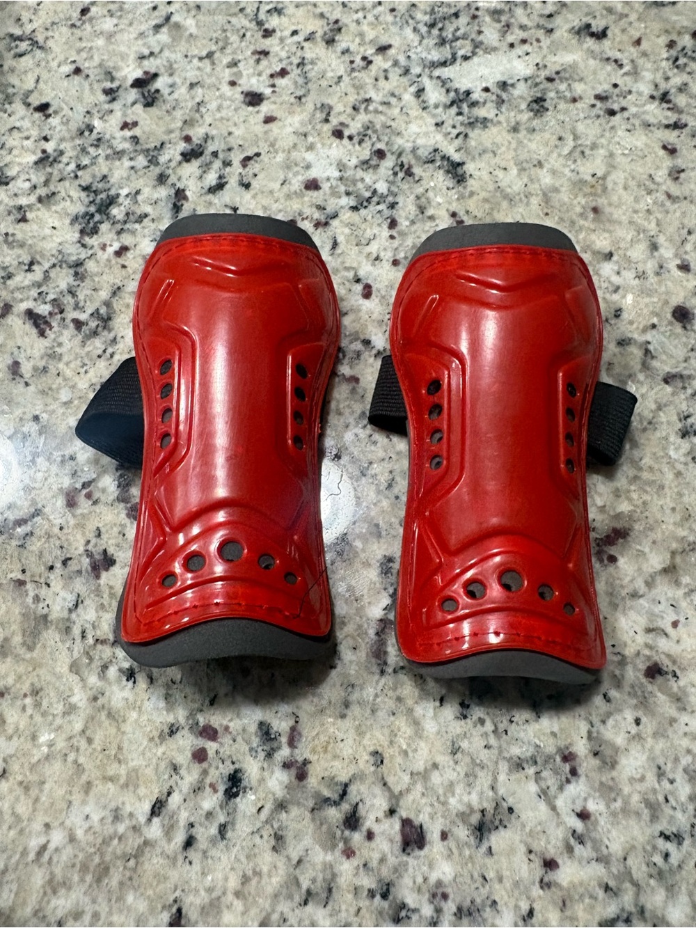 Red and gray toddler soccer shin guards with strap